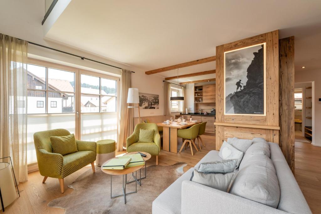 a living room with a couch and chairs and a table at Penthouse No9 in Oberstaufen