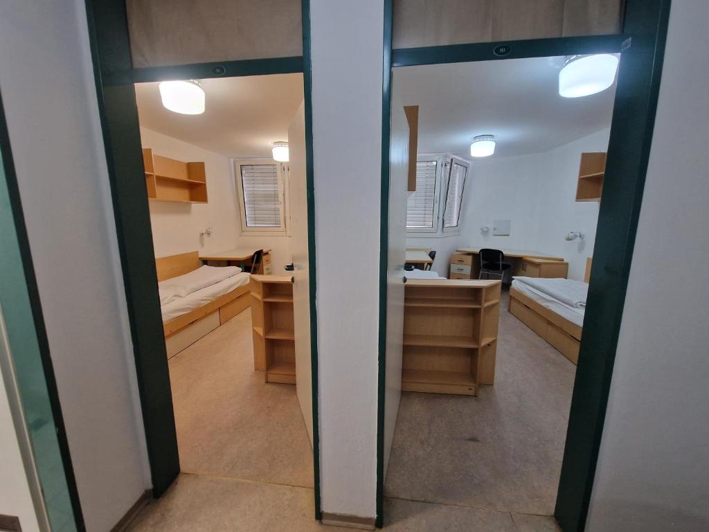 a bathroom with two sinks and a mirror at Hostel Rožna dolina, Dom XIV in Ljubljana