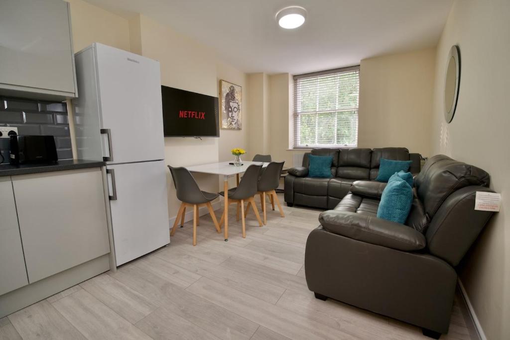 a kitchen and a living room with a couch and a table at Warwick Row Apartments Coventry City Centre - Flat 4 in Coventry