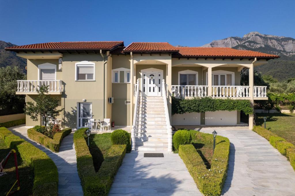 a house with a staircase leading to the front yard at Villa Billena in Skala Potamias