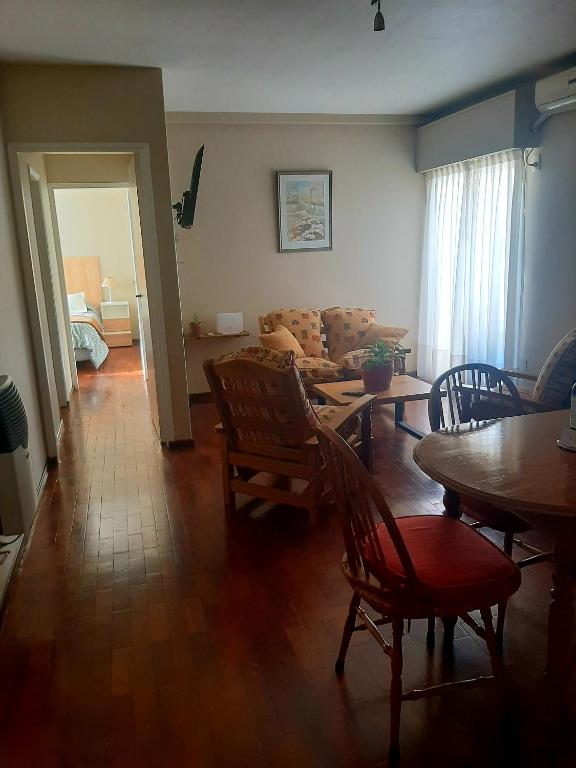 a living room with a couch and a table and chairs at Gutierrez Home in Mendoza