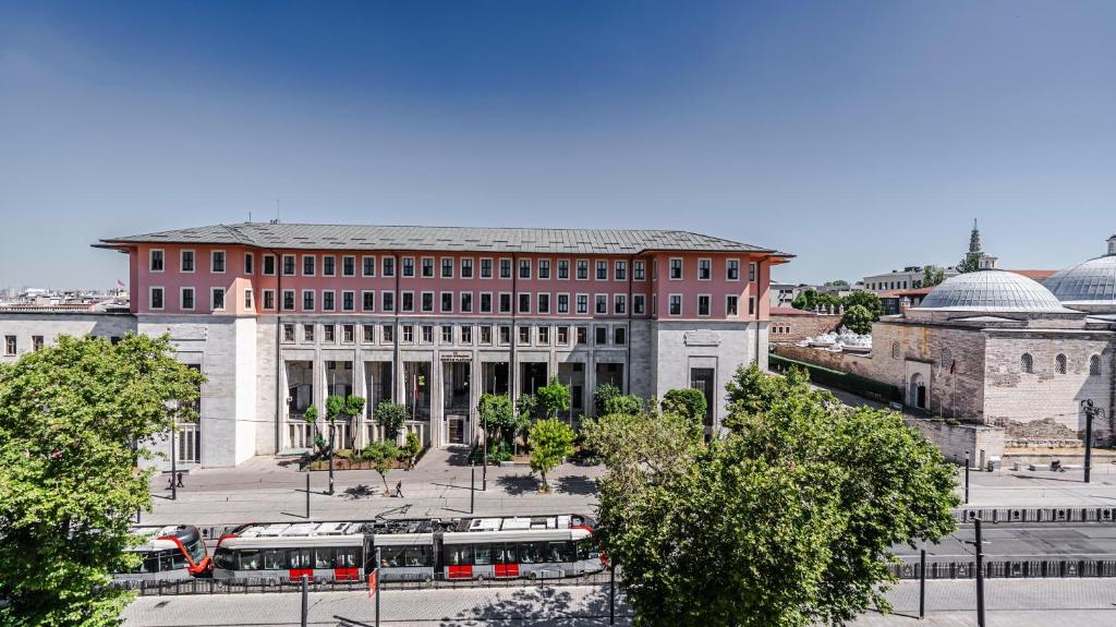 a large building with a bus in front of it at Kent Hotel Beyazıt in Istanbul