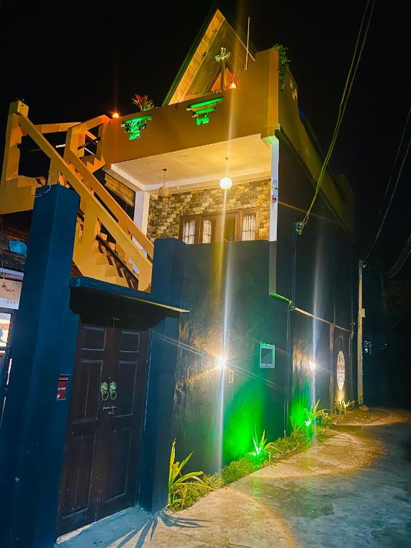 a house at night with green lights on it at Rest N surf Apartments in Ahangama