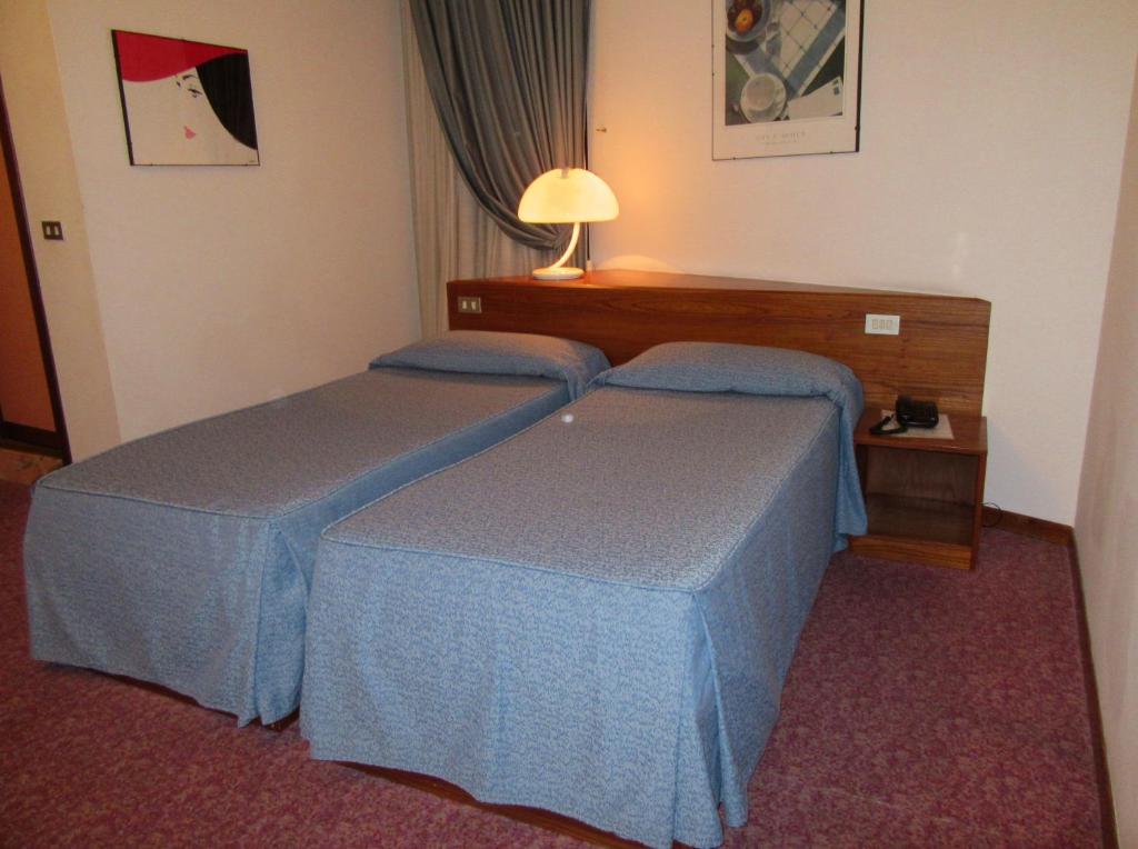 Postel nebo postele na pokoji v ubytování Hotel Giardino