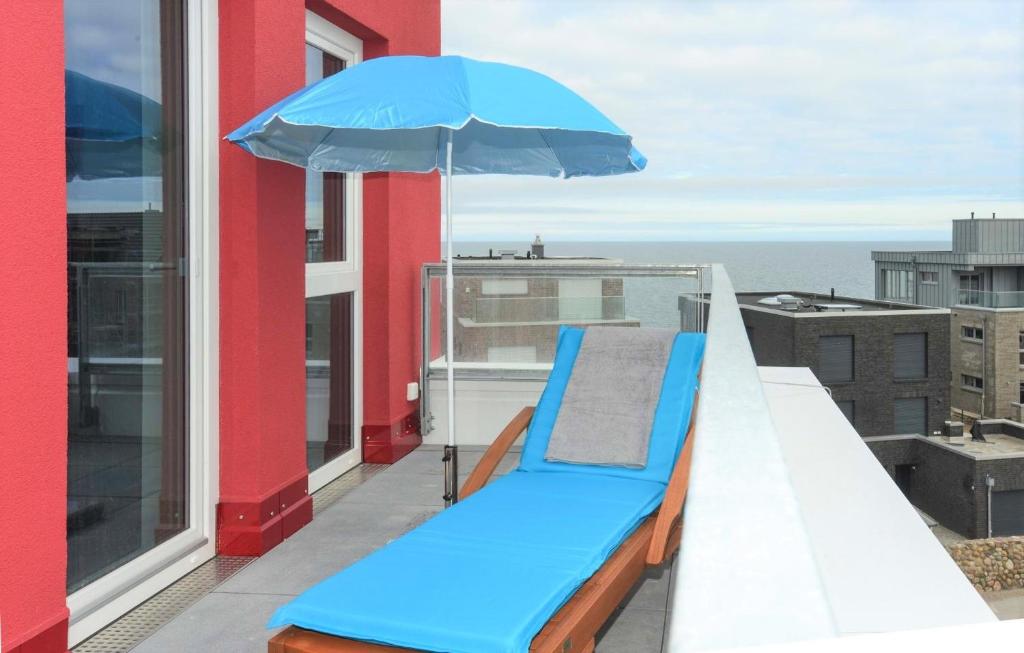 a blue bench on a balcony with an umbrella at Marina Loft in Kappeln
