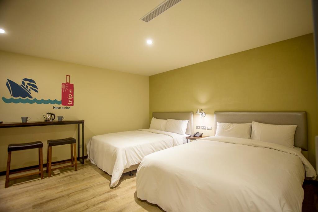 Postel nebo postele na pokoji v ubytování Just Live Inn-Keelung