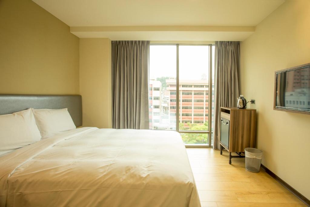 Postel nebo postele na pokoji v ubytování Just Live Inn-Keelung