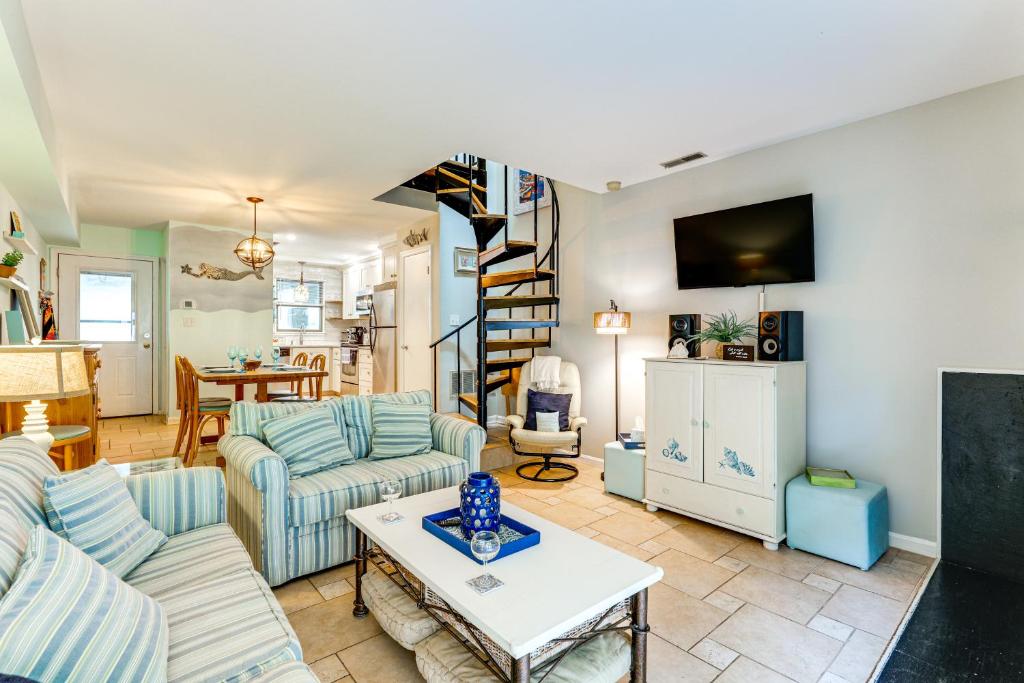 a living room with a couch and a table at about 1 Block to Bethany Beach, Retreat with Pool Access in Bethany Beach