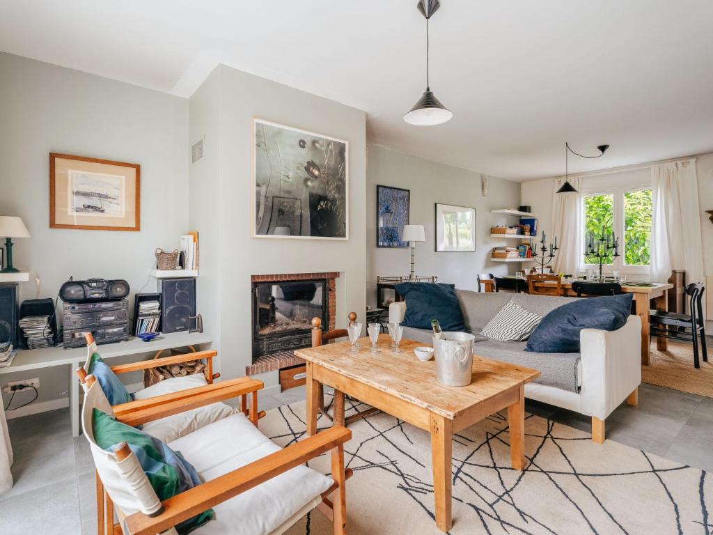 a living room with a table and a couch at Holiday Home Le Nyce by Interhome in Lancieux