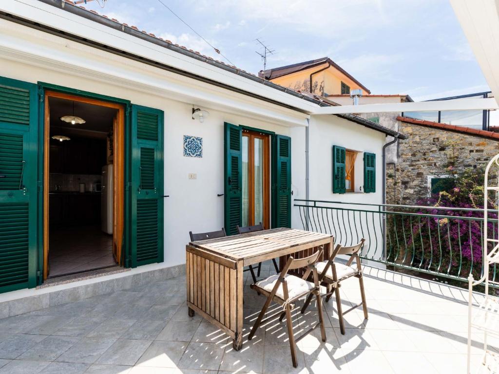 a patio with a wooden table and chairs on a balcony at Holiday Home Ca'de Pauline by Interhome in Gazzelli