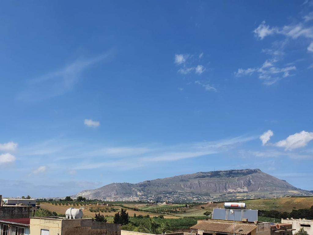 a city with a mountain in the background at Apartment Casa sugli Uliveti by Interhome in Paceco