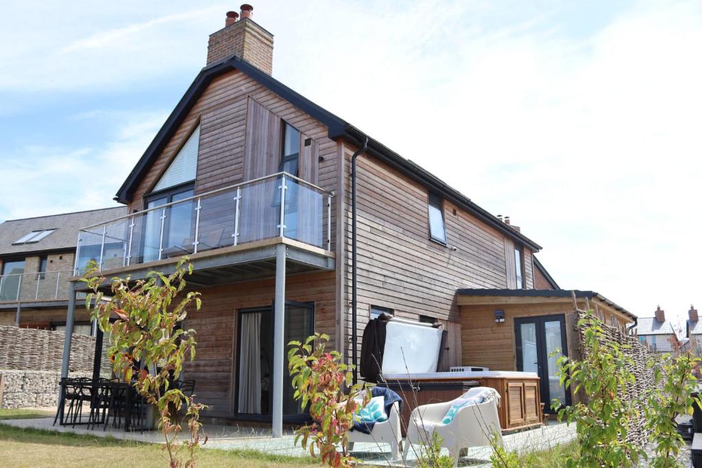 ein Haus mit einem Glasbalkon an der Seite in der Unterkunft Acorn House in Dorchester