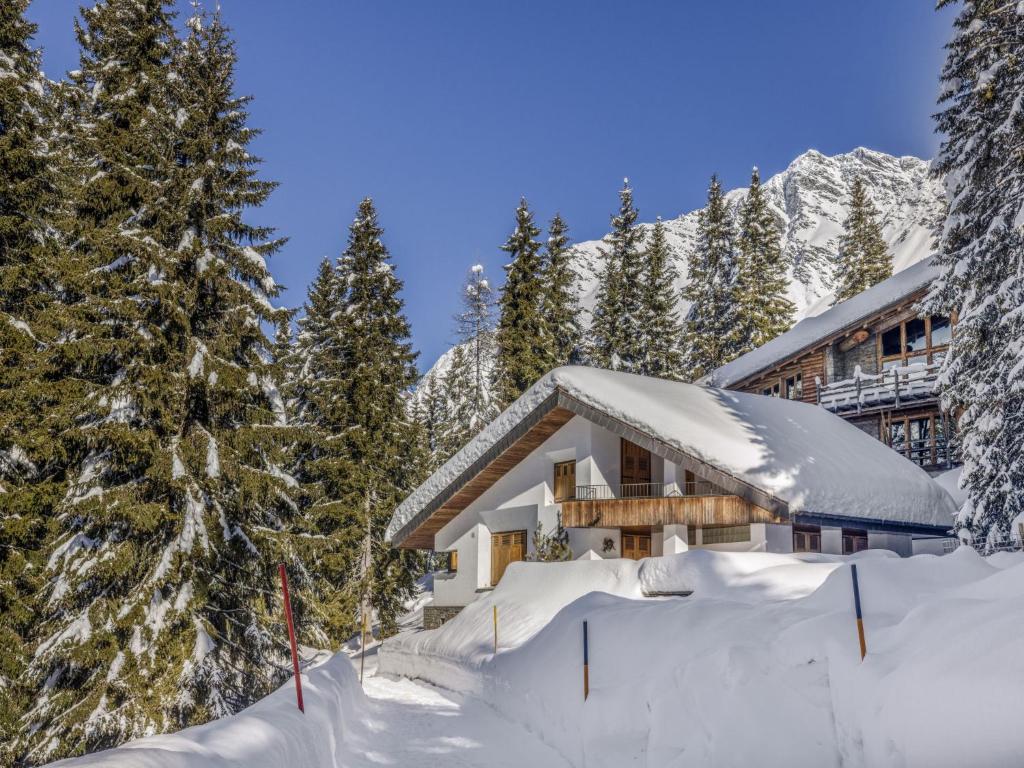 a lodge in the snow with snow covered trees at Apartment Larice by Interhome in San Bernardino