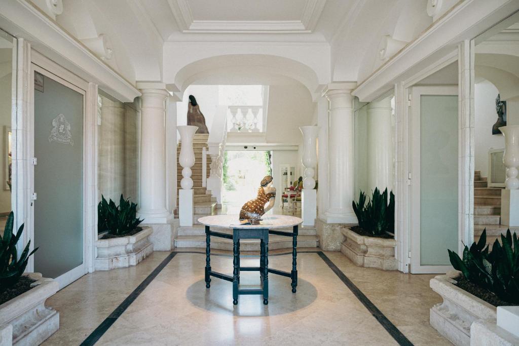 a room with a table with a statue on it at Relais Corte Degli Aragonesi in Ischia