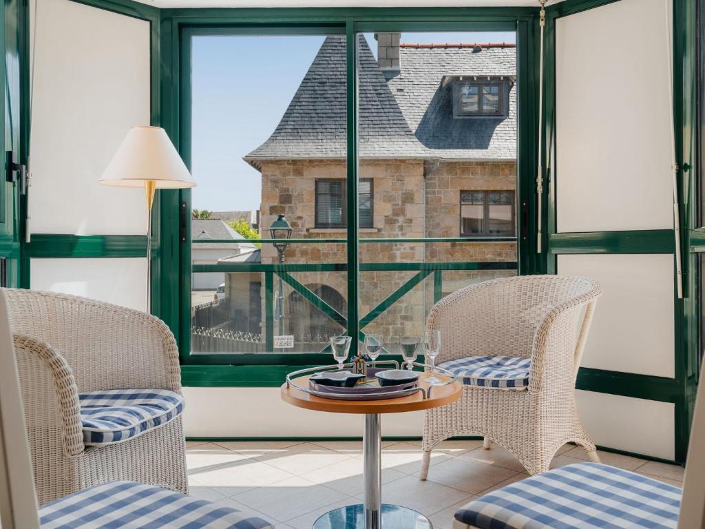 ein Raum mit einem Tisch und Stühlen und einem Fenster in der Unterkunft Apartment Le Prince Noir by Interhome in Dinard