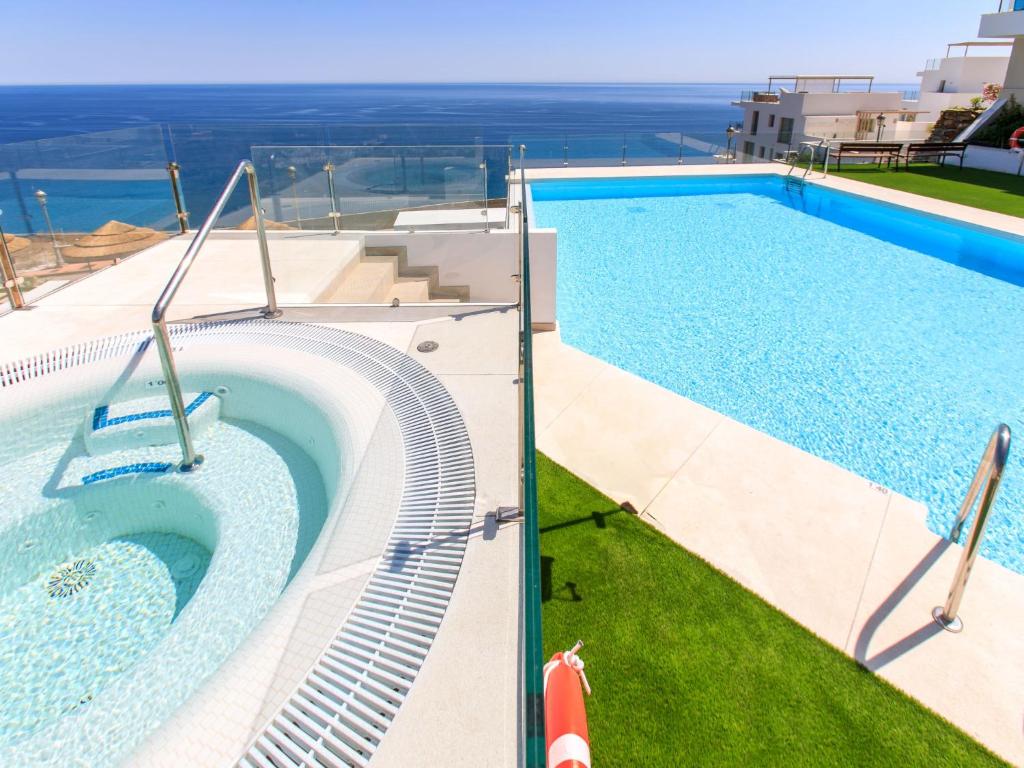 a swimming pool with a view of the ocean at Apartment D'Mediterranea private pool & sauna by Interhome in Torrox Costa