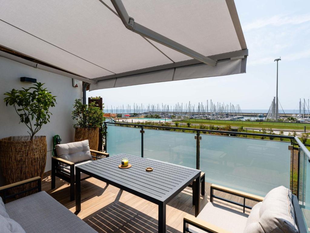 a balcony with a table and a view of the water at Apartment Entre Bateau et Mer by Interhome in Santo Stefano al Mare
