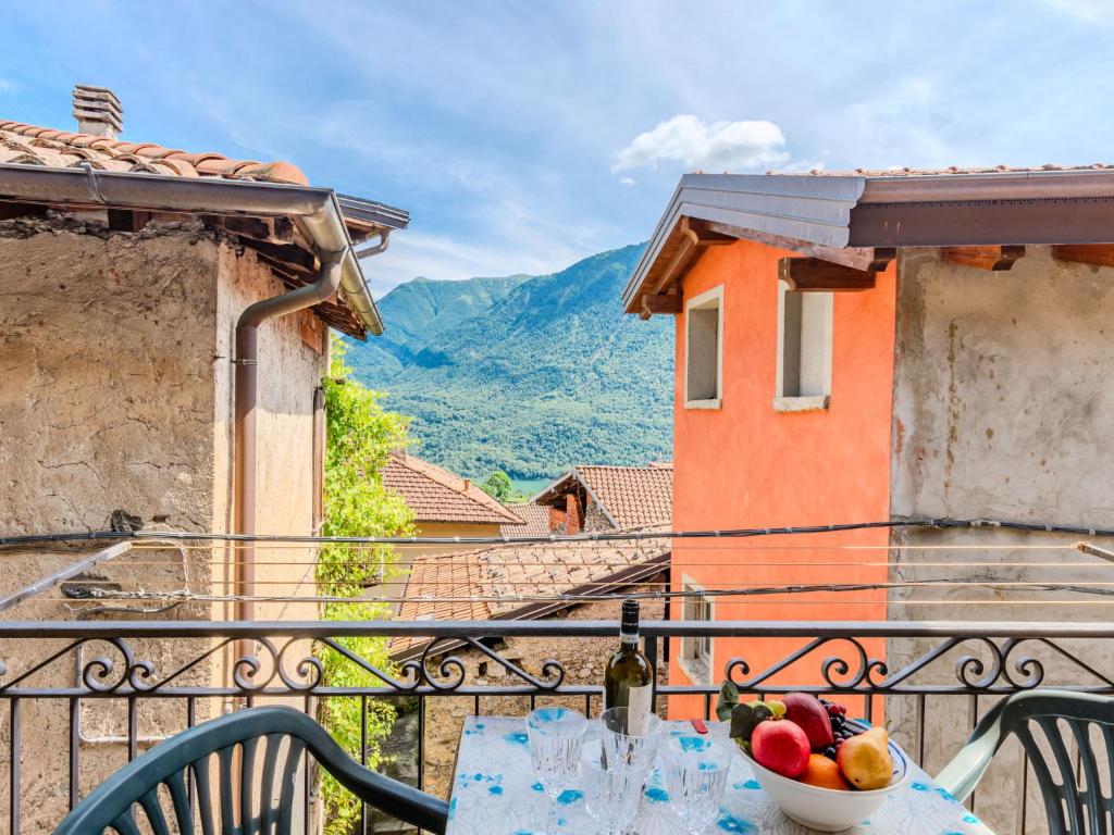 a table with a bowl of fruit on a balcony at Apartment Torchio by Interhome in Carlazzo