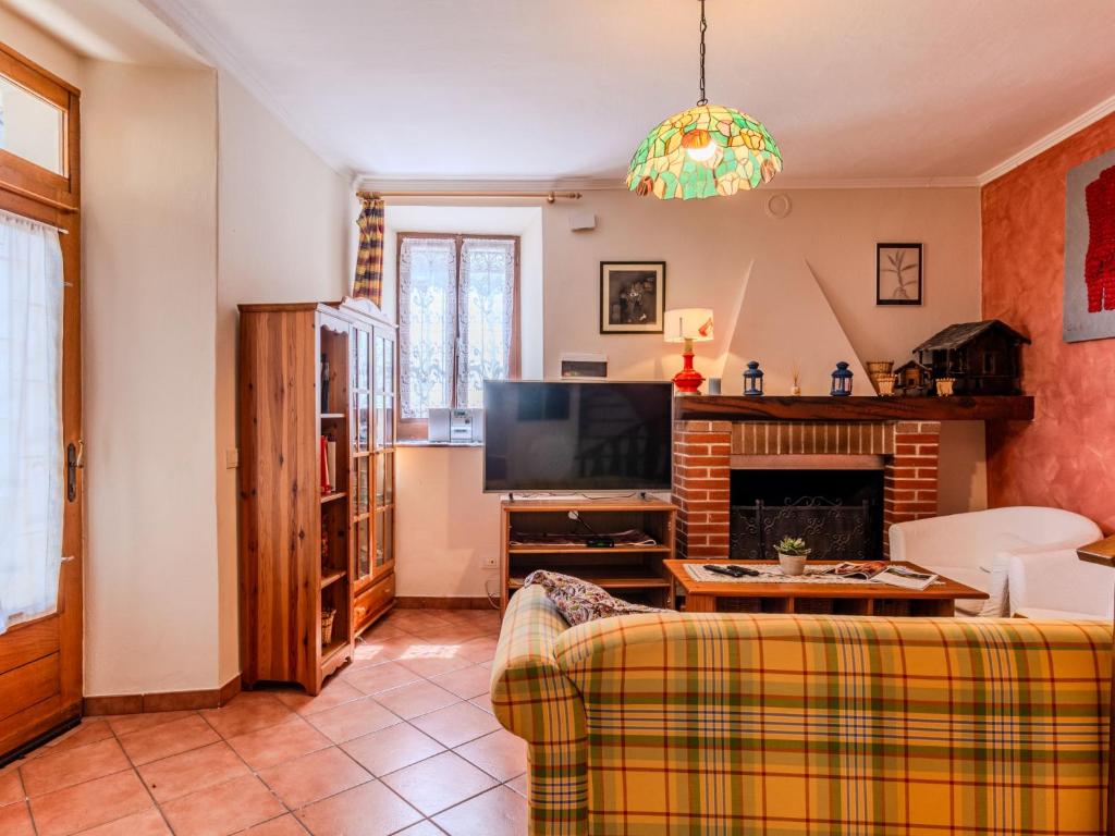 a living room with a couch and a tv at Apartment Torchio by Interhome in Carlazzo