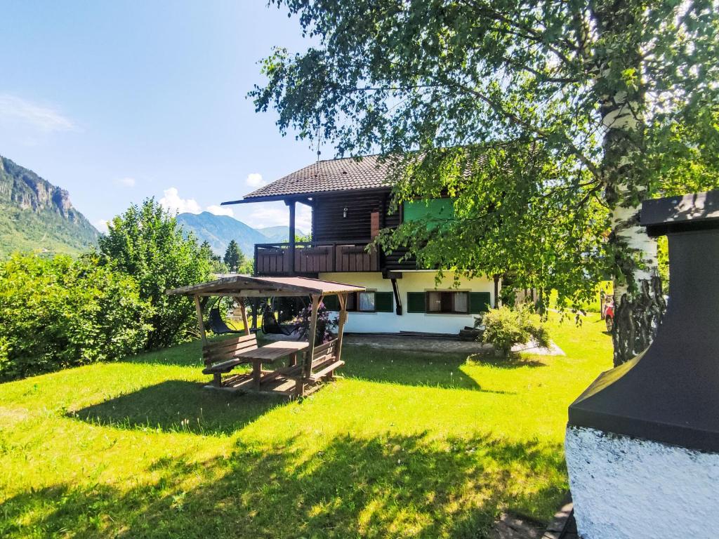 a house with a picnic table in the grass at Chalet Altavista by Interhome in Ziano di Fiemme