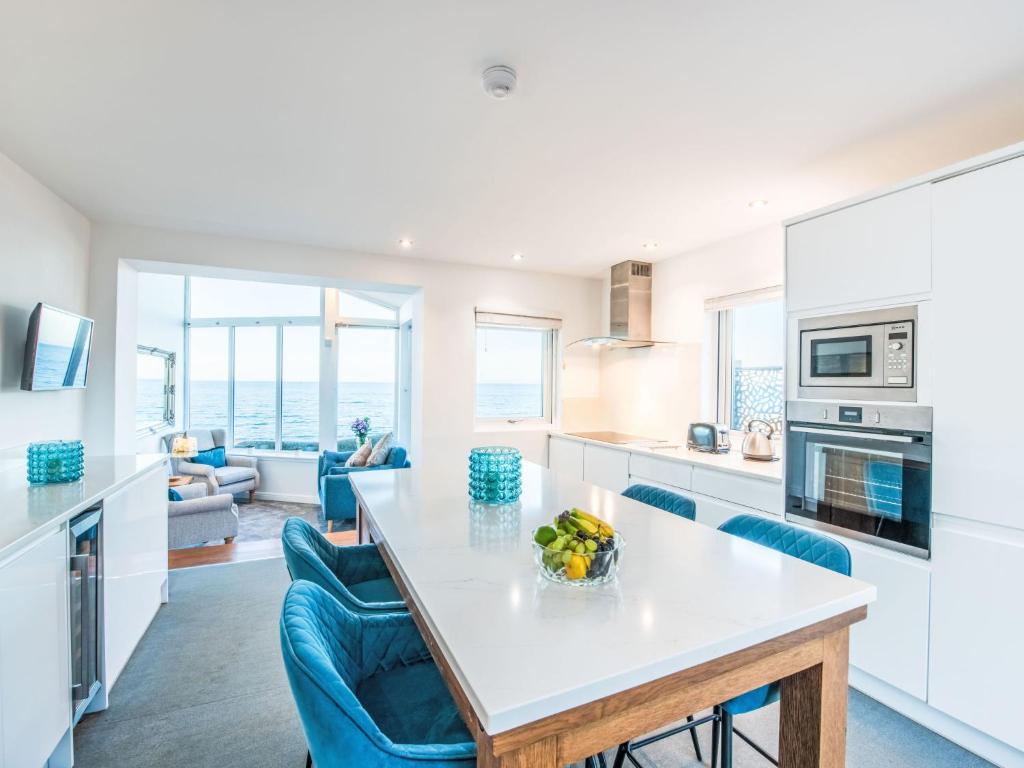 a kitchen with a table and chairs and a living room at Holiday Home Waters Edge by Interhome in Lossiemouth