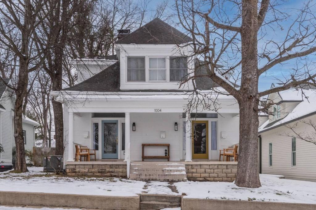 a white house with a porch in the snow at Chic 2 Bed 2 Bath, In 12 South in Nashville