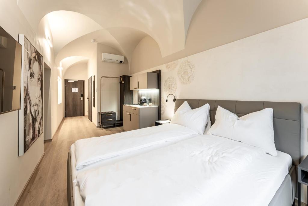 Postel nebo postele na pokoji v ubytování Aparthotel Lavilo Main Square