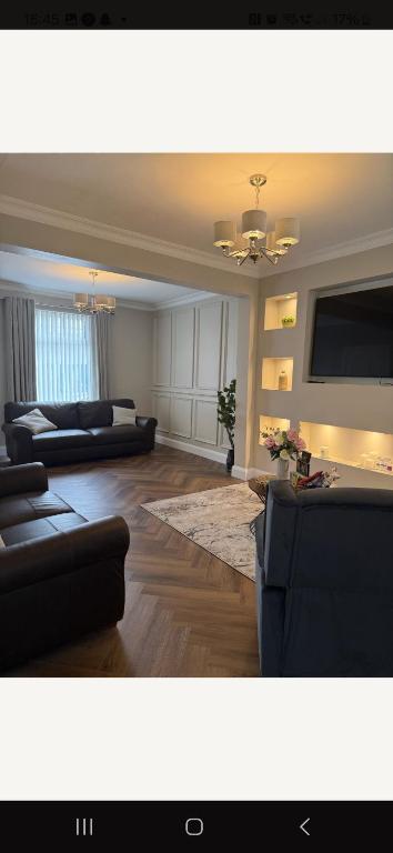 a large living room with couches and a tv at Harding Haven in Derry Londonderry