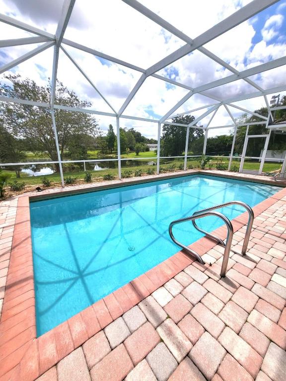 a large swimming pool with a glass roof at Emerald House in Bradenton
