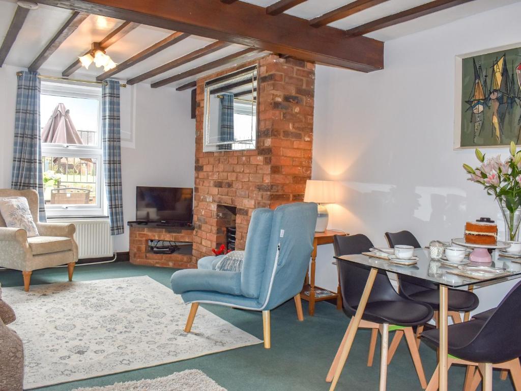a living room with a table and chairs at Kathys Cottage in Kings Lynn