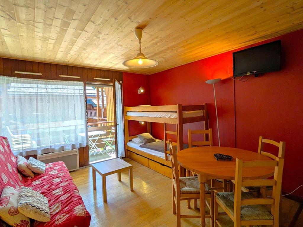 - un salon avec une table et des lits superposés dans l'établissement Studio au Centre de La Clusaz - Balcon, Garage, Proche Pistes et Commerces - FR-1-459-67, à La Clusaz