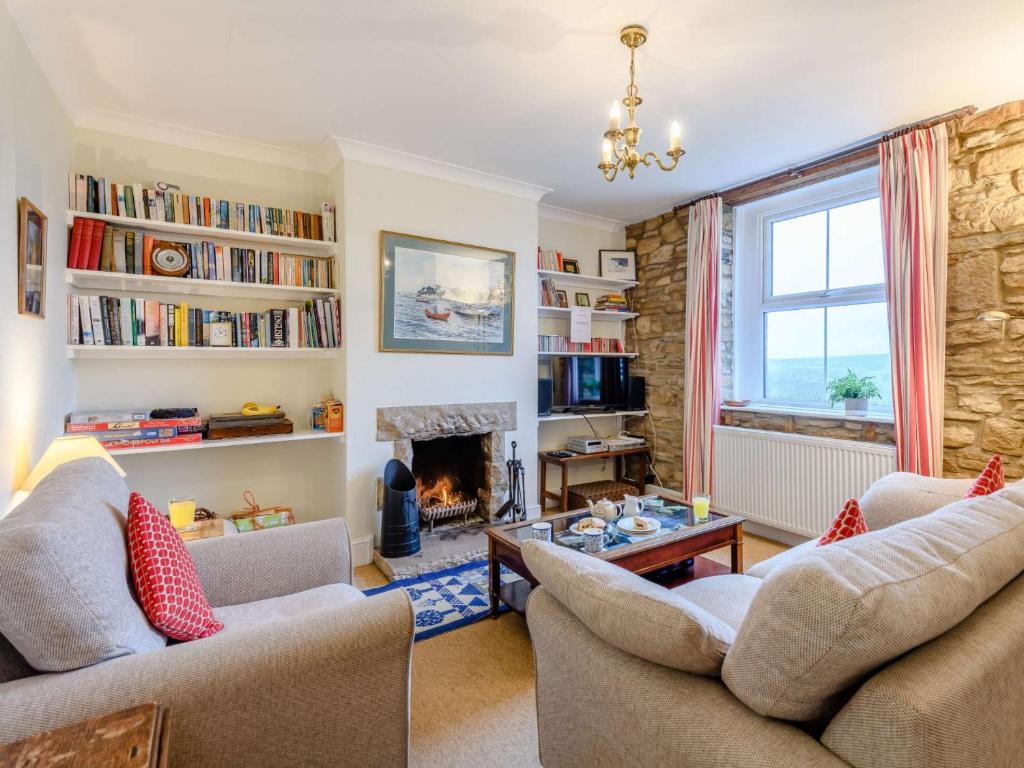 a living room with two couches and a fireplace at 2 Bed in Langton Matravers DC068 in Langton Matravers