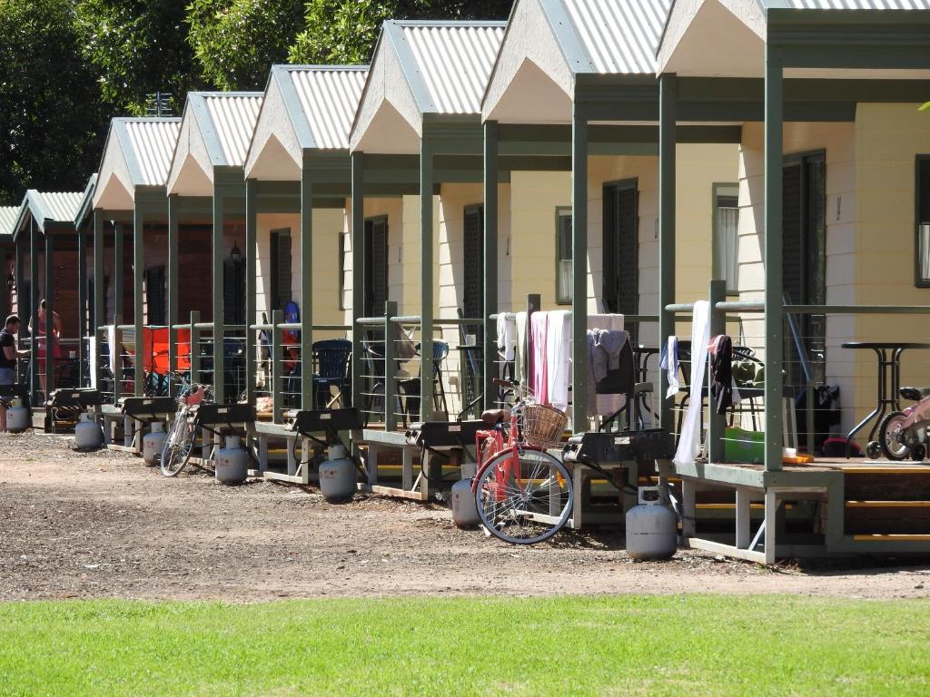 a row of parked motorcycles in front of a building at Victoria Lake Holiday Park in Shepparton