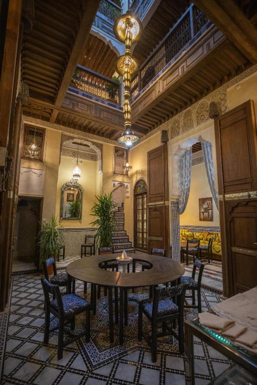 a large room with a table and chairs at Saphiryad in Fez