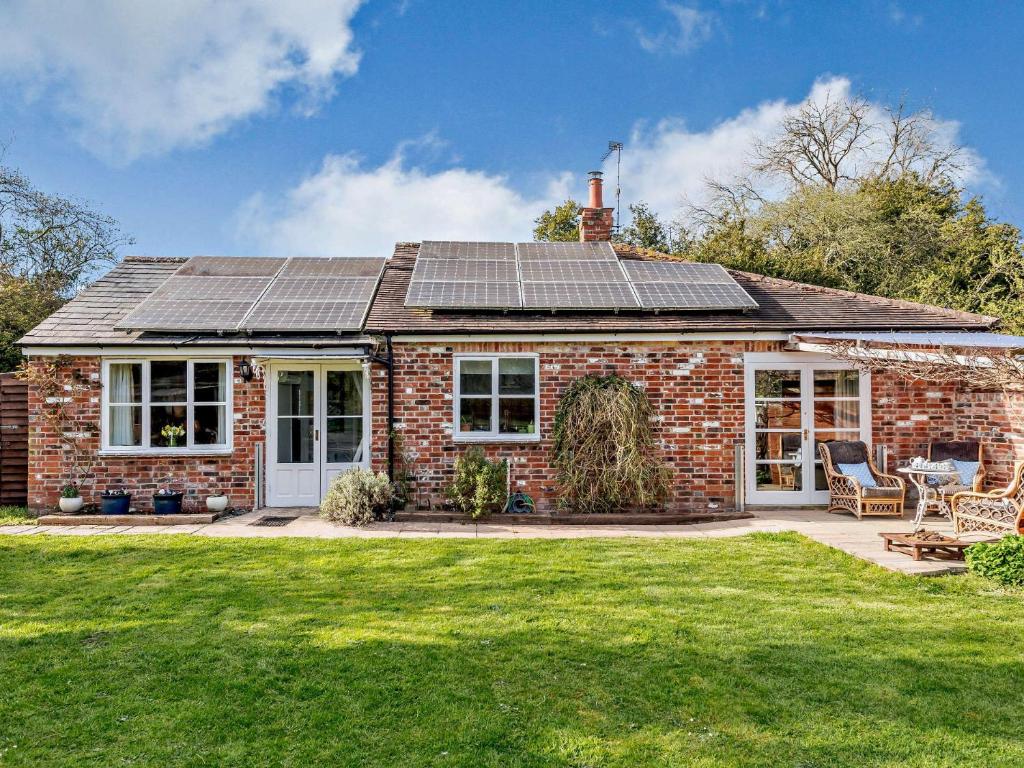a brick house with solar panels on the roof at 2 bed in Blandford Forum STOMI in Durweston