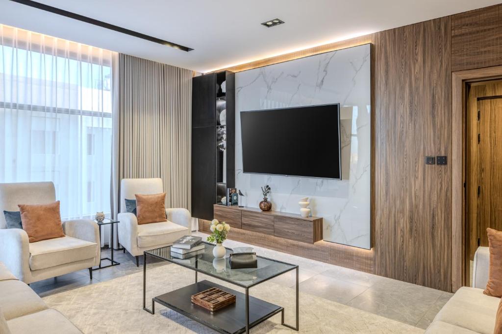 a living room with a flat screen tv on a wall at Super Luxury SweetHome in Medina