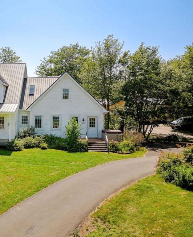 a white house with a winding driveway at The Laurel Leaf at Annes Windy Poplars in Cavendish