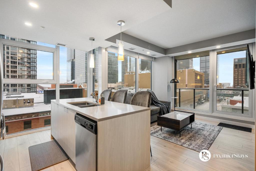 a kitchen and living room with a view of a city at Central Downtown near Rogers Sleeps 6 with Two Queen Beds and Parking in Edmonton