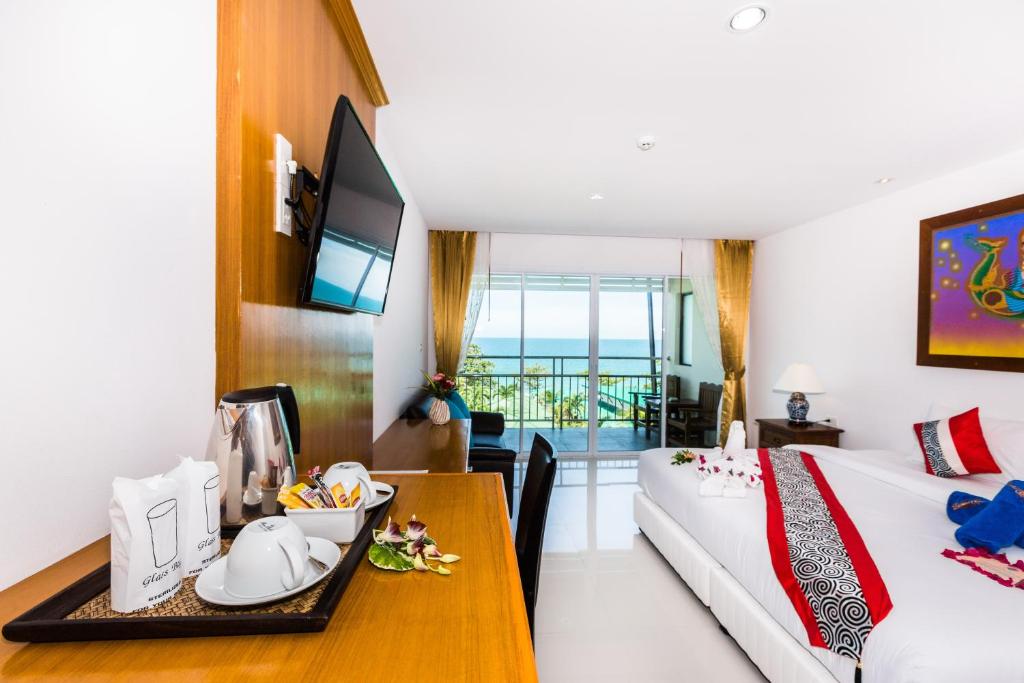a hotel room with a bed and a dining table at Lamai Coconut Beach Resort in Lamai