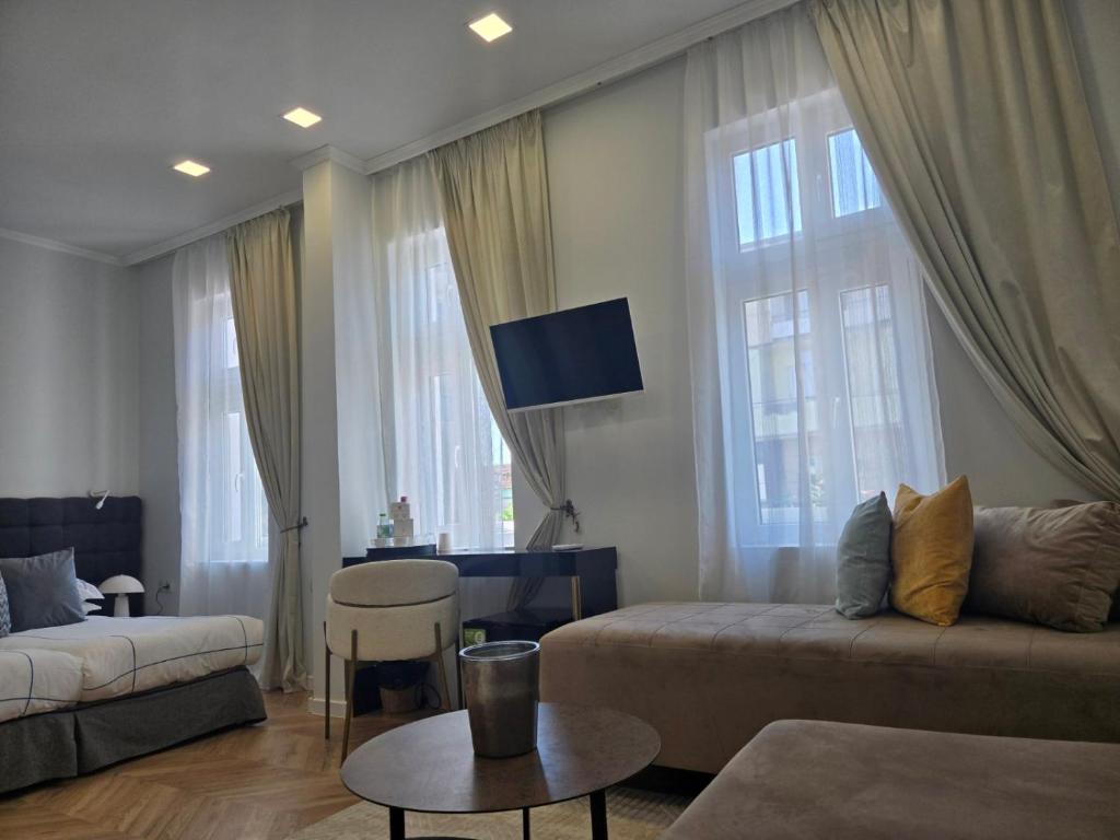 a living room with a couch and a table at La Maison des Fleurs FREE PARKING in Pazardzhik