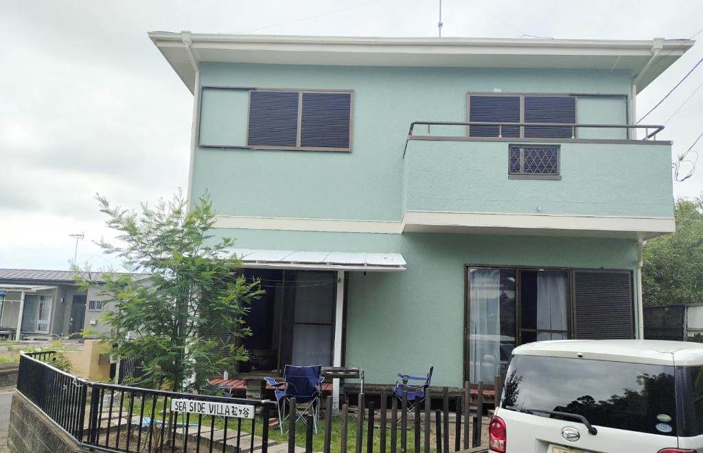 a blue house with a car parked in front of it at Seaside Villa Matsugaya - Vacation STAY 19447 in Sammu
