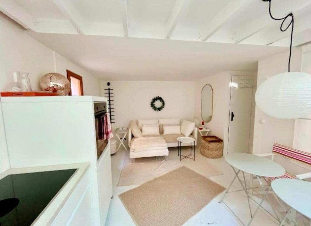 a living room with a white couch and a table at Contemporary-style pavilion in Narbonne