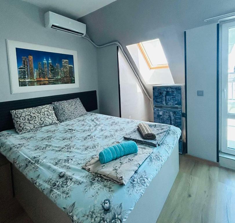 a bedroom with a bed with a blue comforter at Joy Station Appartment 2 in Sofia