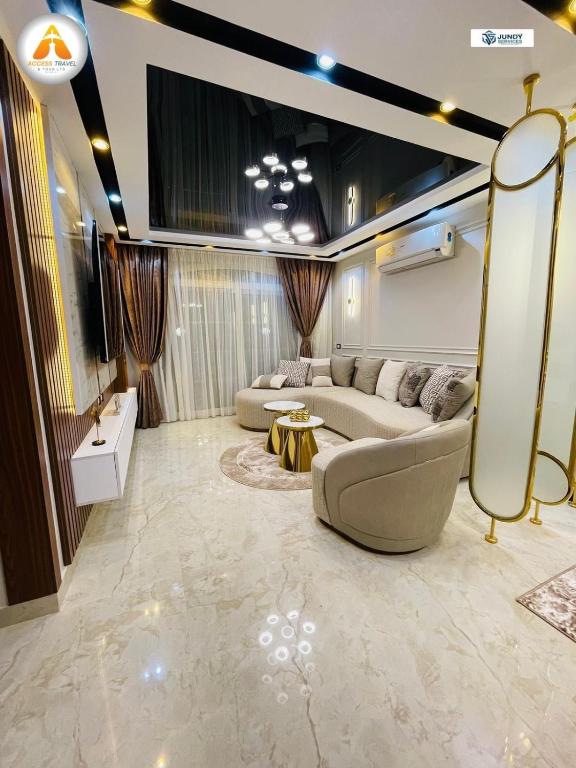 a living room with two couches and a tv at Stylish & Trendy in Cairo