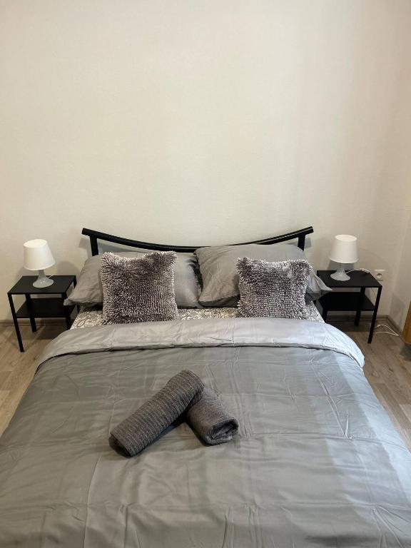 a large bed in a bedroom with two end tables at New May Apartment in Staré Mesto