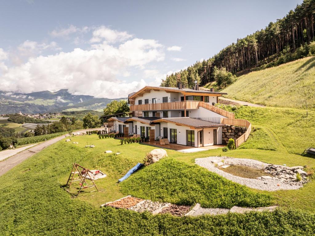 an aerial view of a house on a hill at Stabingerhof Chalets & Apartment-Farm stay in Bressanone