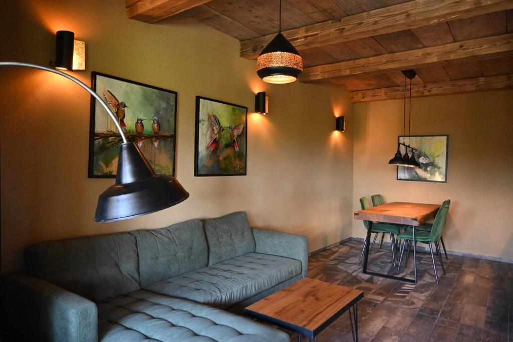 a living room with a couch and a table at Lavender Hill, Eko Resort & Wellness in Polzela