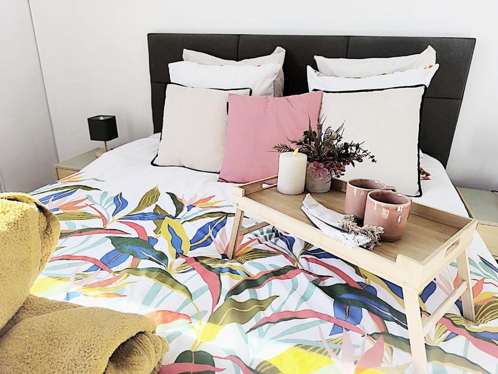 a bed with a table with plants on it at LeRelaisdOdile-Idéal Pro & Famille-Proche Métro-Fort de Mons in Mons-en-Baroeul