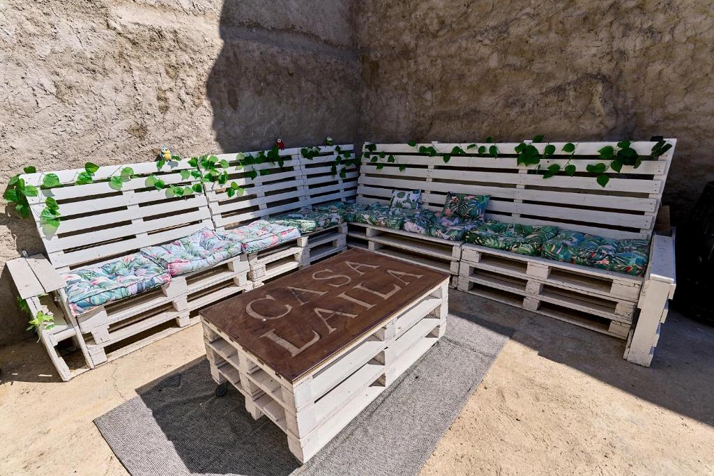 two wooden benches with plants on top of them at Casa Rural Laila in Endrinal