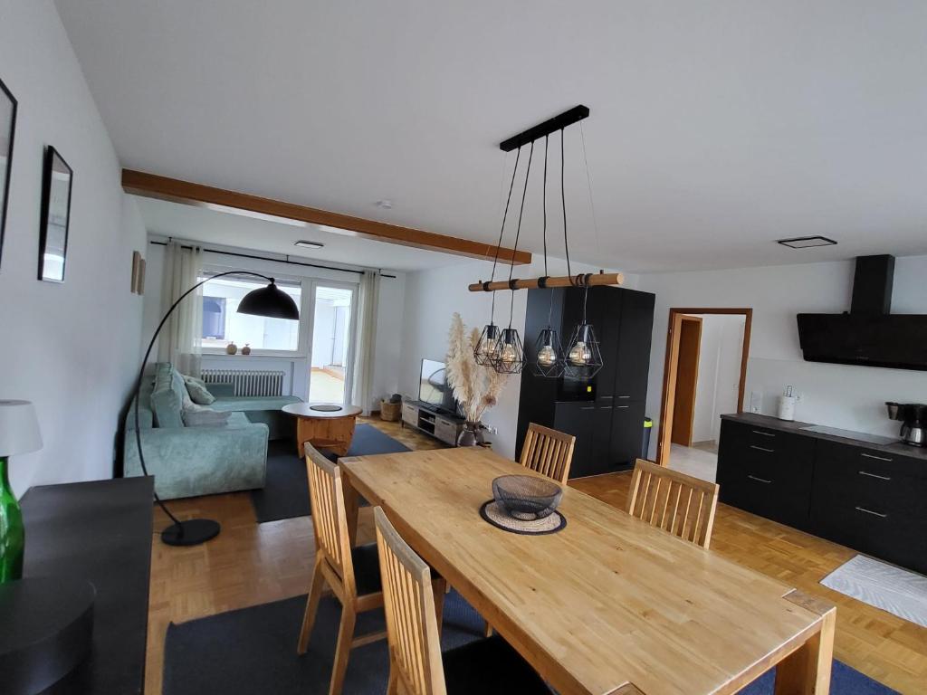 a dining room and living room with a wooden table at Moselluft1 in Leiwen